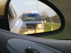 Police in rear view mirror